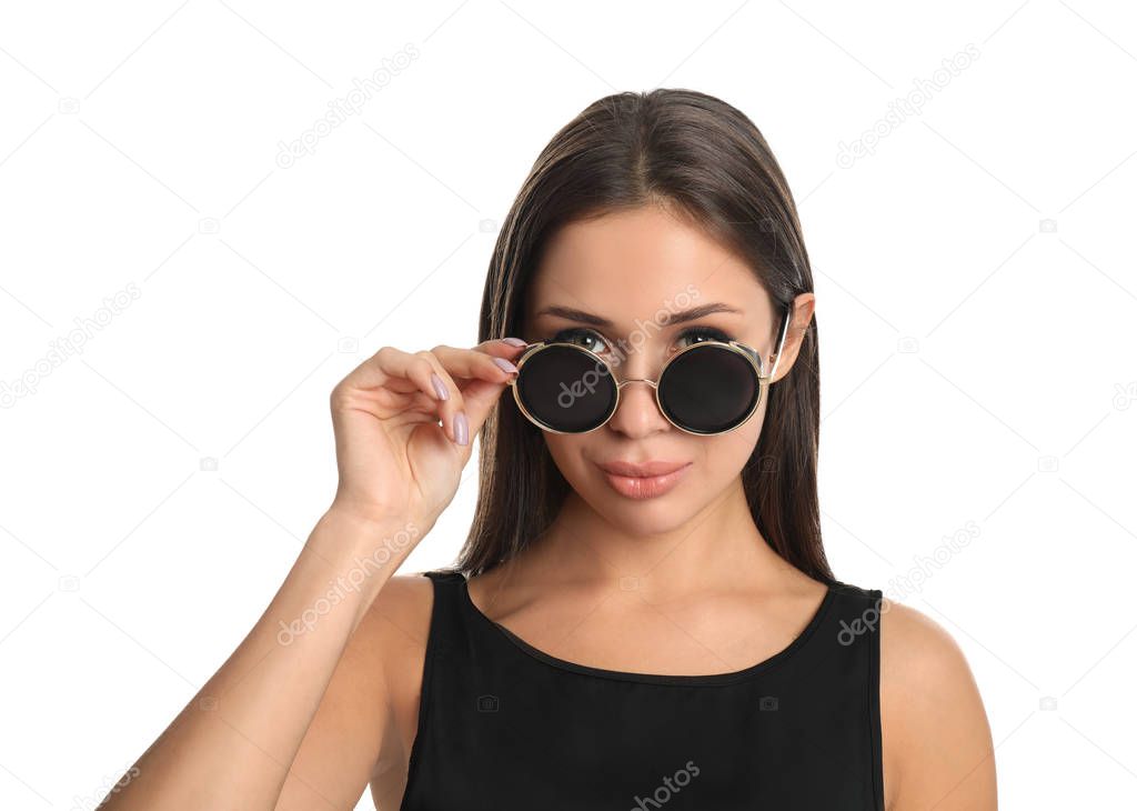 Beautiful young woman wearing sunglasses on white background