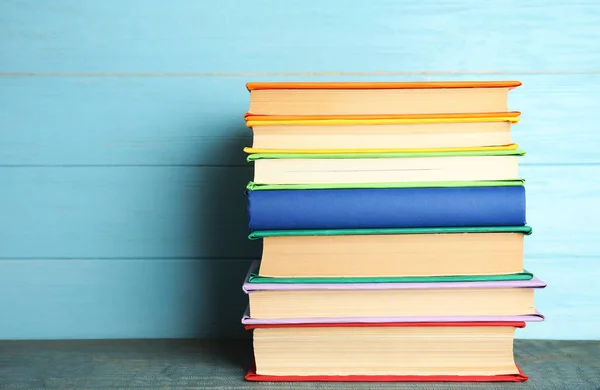 Stapel Kleurrijke Boeken Lichtblauwe Houten Tafel — Stockfoto