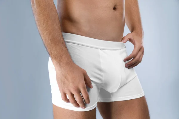 Man in white underwear on light grey background, closeup — Stock Photo, Image