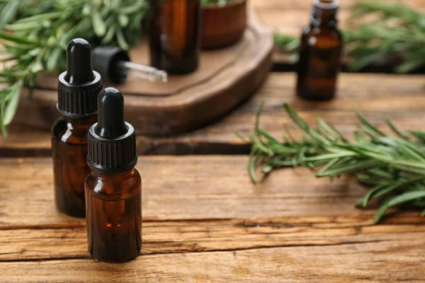 Bottles Rosemary Essential Oil Wooden Table Space Text — Stock Photo, Image
