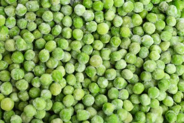 Arka plan olarak lezzetli donmuş bezelyeler, üst manzara. Sebze koruma