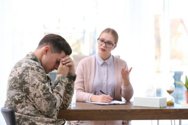 Psychotherapist working with military officer in office