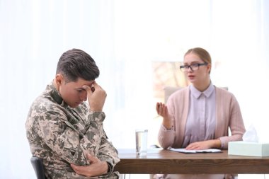 Psychotherapist working with military officer in office