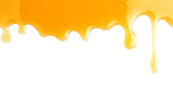 Dulce miel fresca que fluye sobre fondo blanco — Foto de Stock