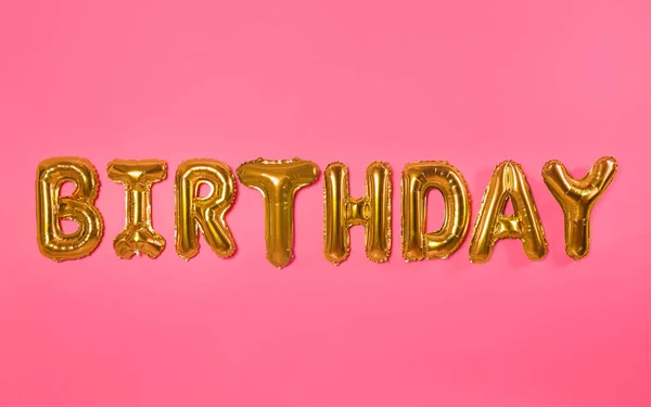 Word Urodziny Wykonane Folii Balon Litery Różowym Tle — Zdjęcie stockowe