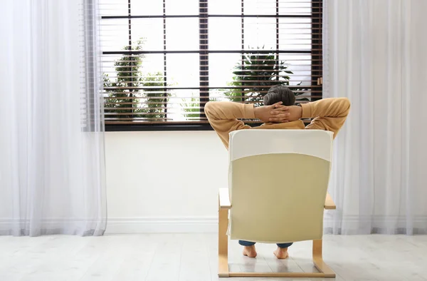 Homem Relaxando Poltrona Perto Janela Casa Vista Para Trás Espaço — Fotografia de Stock