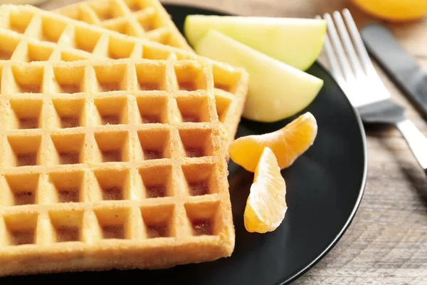 Waffles with fruits served on wooden table, closeup. Delicious b — Stock Photo, Image