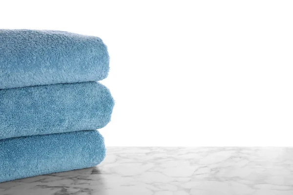 Fresh towels on marble table against white background. Space for — Stock Photo, Image