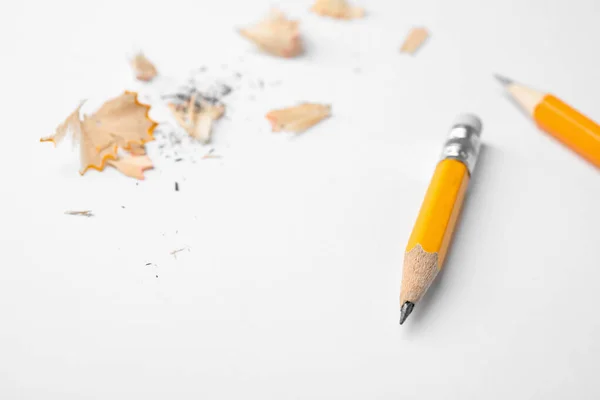 Графітові олівці та стружки на білому тлі, крупним планом — стокове фото