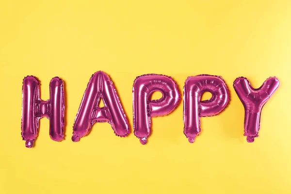 Woord Happy Gemaakt Van Roze Folie Ballonnen Letters Gele Achtergrond — Stockfoto