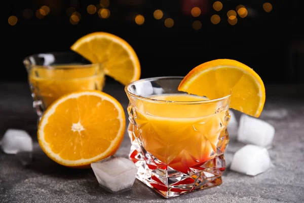 Fresh alcoholic Tequila Sunrise cocktail on grey table