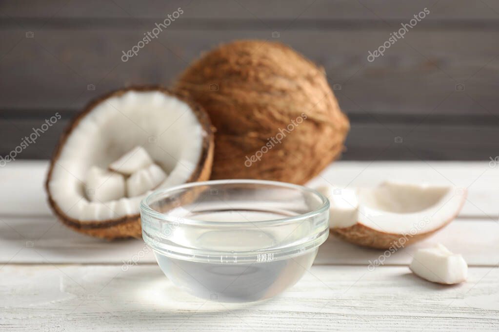 Coconut oil in bowl on white wooden table