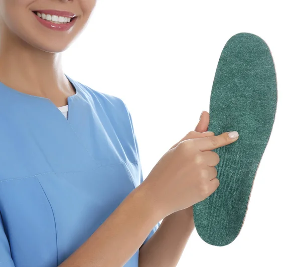 Female orthopedist showing insole on white background, closeup — Stock Photo, Image