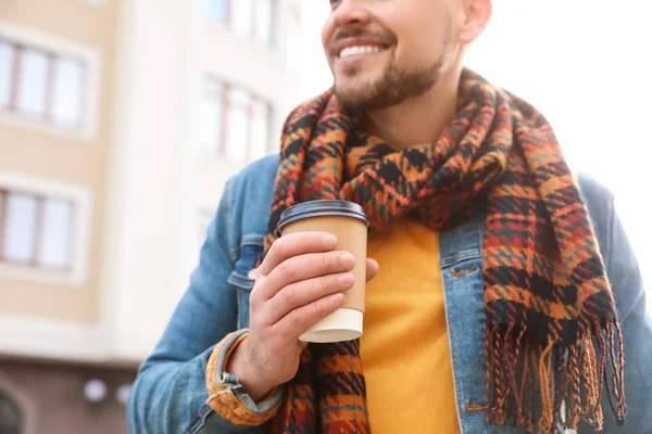 Man with cup of coffee on city street in morning, closeup — Stock Photo, Image