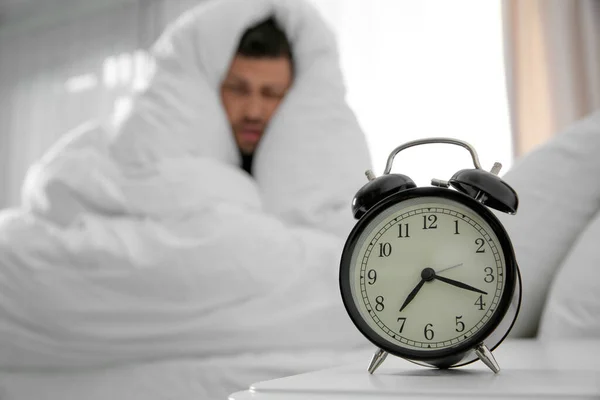 Alarm clock and man at home in morning. Space for text — Stock Photo, Image