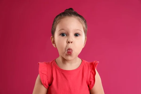 Porträt des niedlichen kleinen Mädchens auf rosa Hintergrund — Stockfoto
