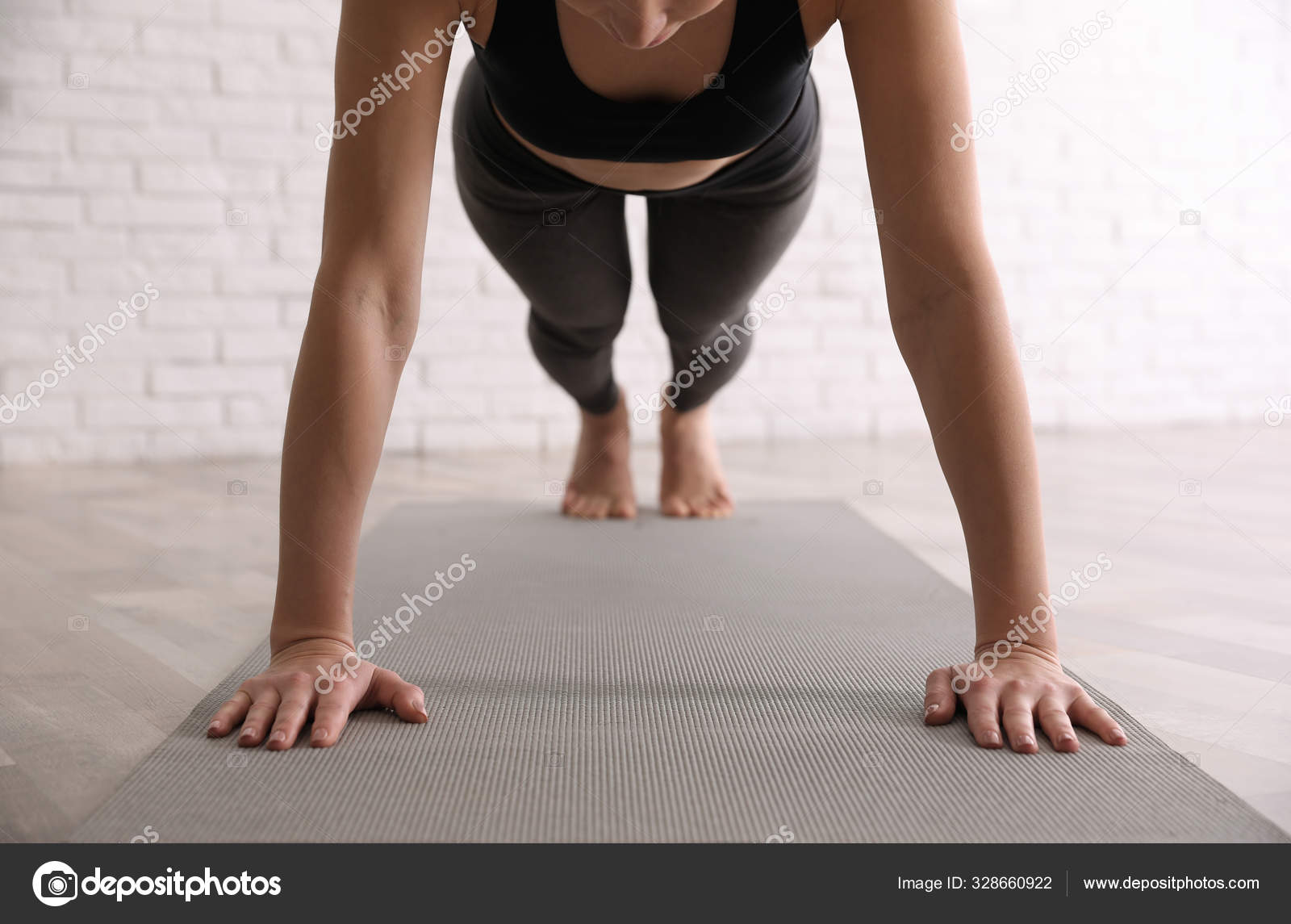 Young woman practicing supported shoulder stand asana in yoga
