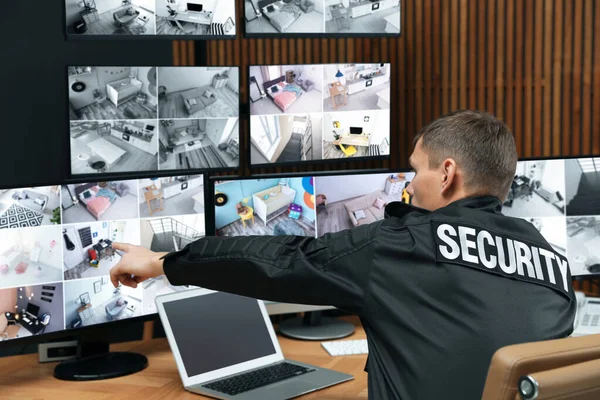 Security guard with portable transmitter monitoring modern CCTV — 스톡 사진