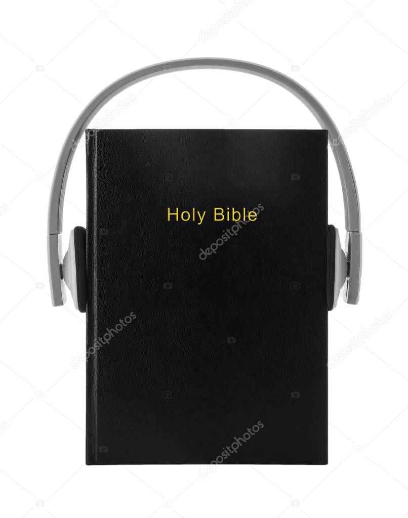 Bible and headphones on white background. Religious audiobook