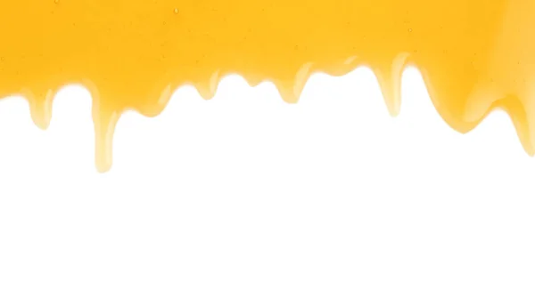 Frischer süßer Honig fließt auf weißem Hintergrund — Stockfoto