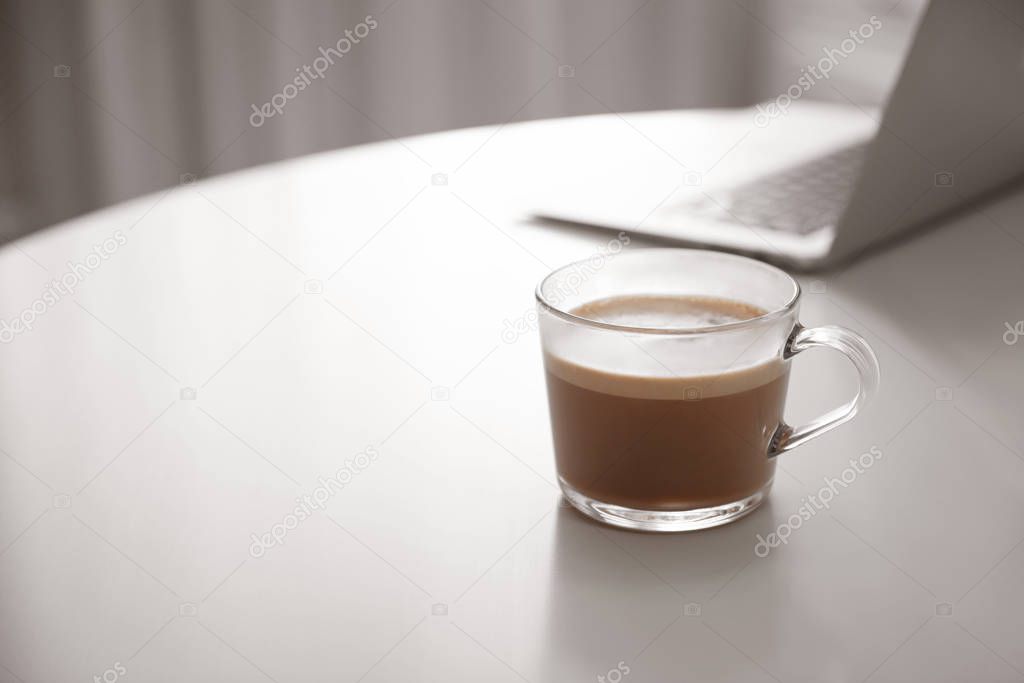 Cup of hot coffee on white table indoors in morning. Space for t