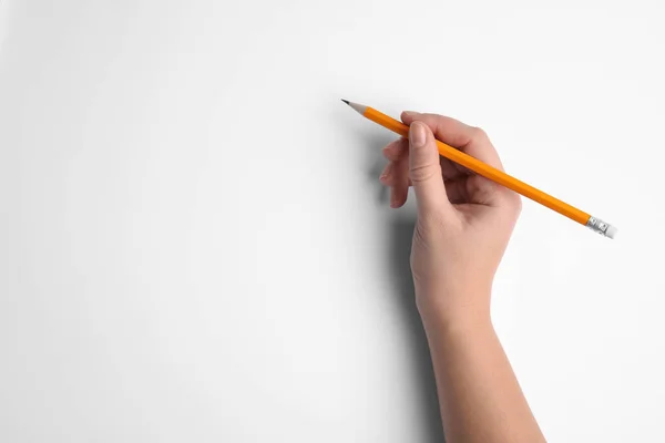 Nő kezében ceruza fehér háttér, felső nézet — Stock Fotó