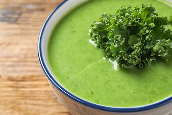 Tasty kale soup on wooden table, closeup — 스톡 사진