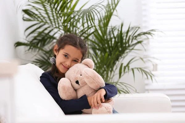 Πορτρέτο του χαριτωμένο κοριτσάκι με αρκουδάκι παιχνίδι στο σαλόνι — Φωτογραφία Αρχείου