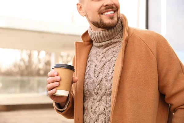 Man with cup of coffee on city street in morning, closeup — Stock Photo, Image