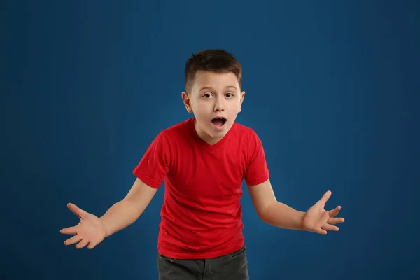 Retrato de menino pré-adolescente emocional em fundo azul — Fotografia de Stock