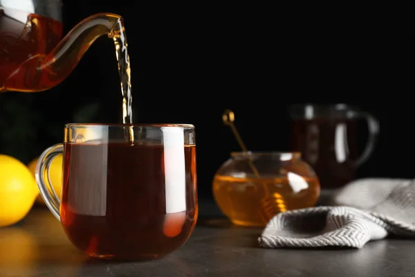 Delicious Tea Pouring Cup Honey Grey Table — Stock Photo, Image