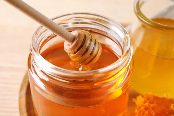 テーブルの上のガラスにディップからおいしい蜂蜜を滴下 クローズアップ — ストック写真