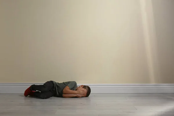 Little Boy Closing Face Hands Lying Floor Yellow Wall Space — 스톡 사진