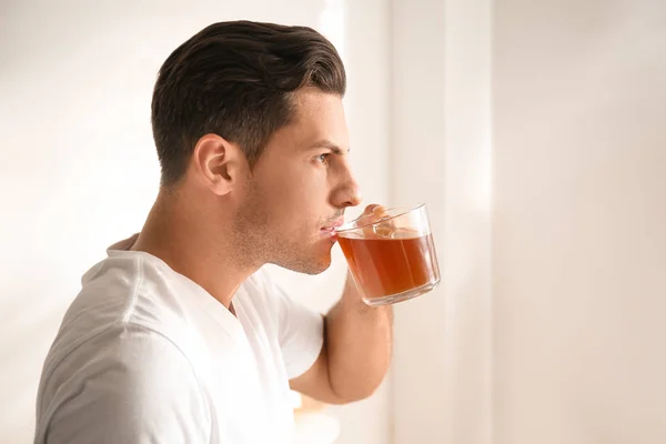 Man with cup of tea indoors. Lazy morning — Stok fotoğraf