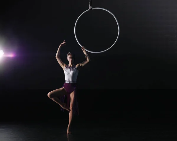 Mujer joven realizando elemento acrobático en anillo aéreo en interiores . —  Fotos de Stock