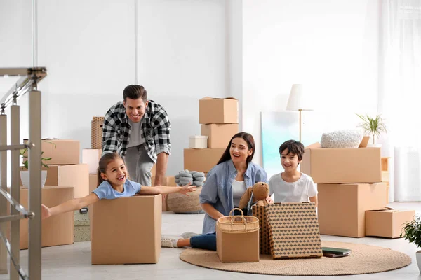 Happy family having fun while unpacking moving boxes at their ne — Stock Photo, Image