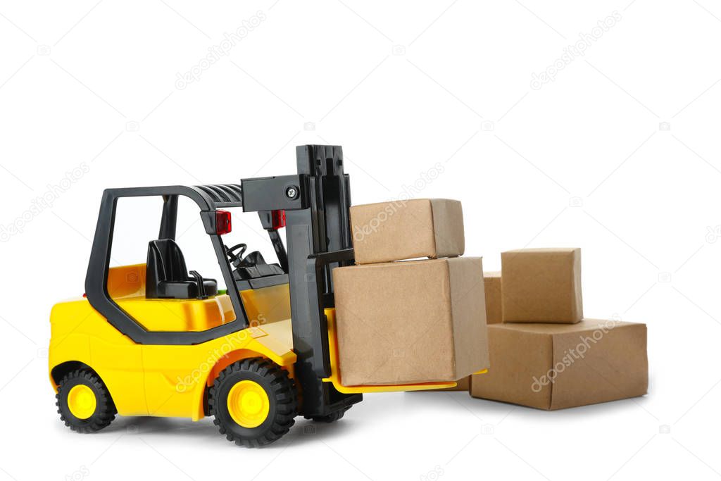 Toy forklift with boxes isolated on white. Logistics and wholesa