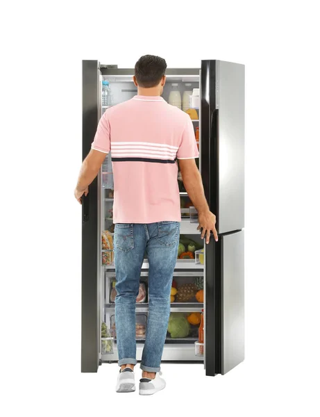Человек Рядом Открытым Холодильником Белом Фоне Вид Сзади — стоковое фото