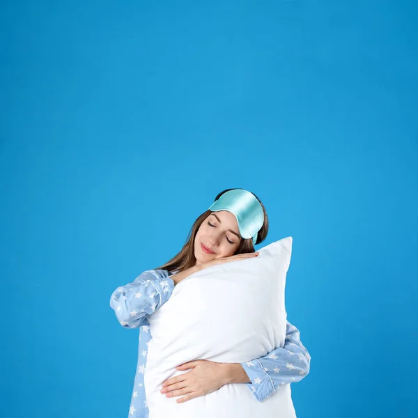 Bella donna con cuscino su sfondo azzurro. Ora di andare a letto — Foto Stock