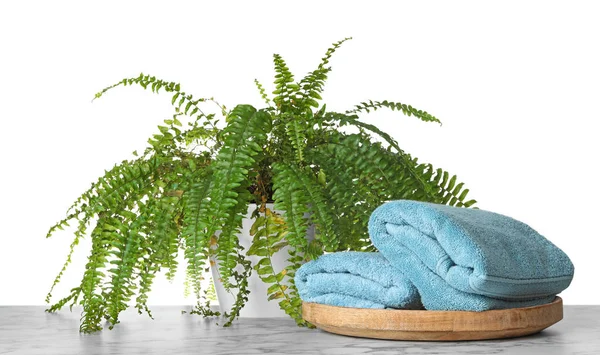 Fresh bath towels on table against white background — Stock Photo, Image
