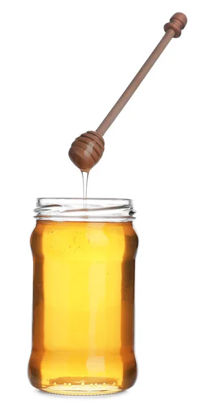 Honig tropft aus Holzlöffel in Glas isoliert auf weiß — Stockfoto