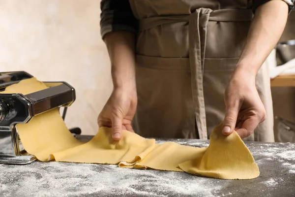 Woman preparing dough with pasta maker machine at grey table, cl — 스톡 사진