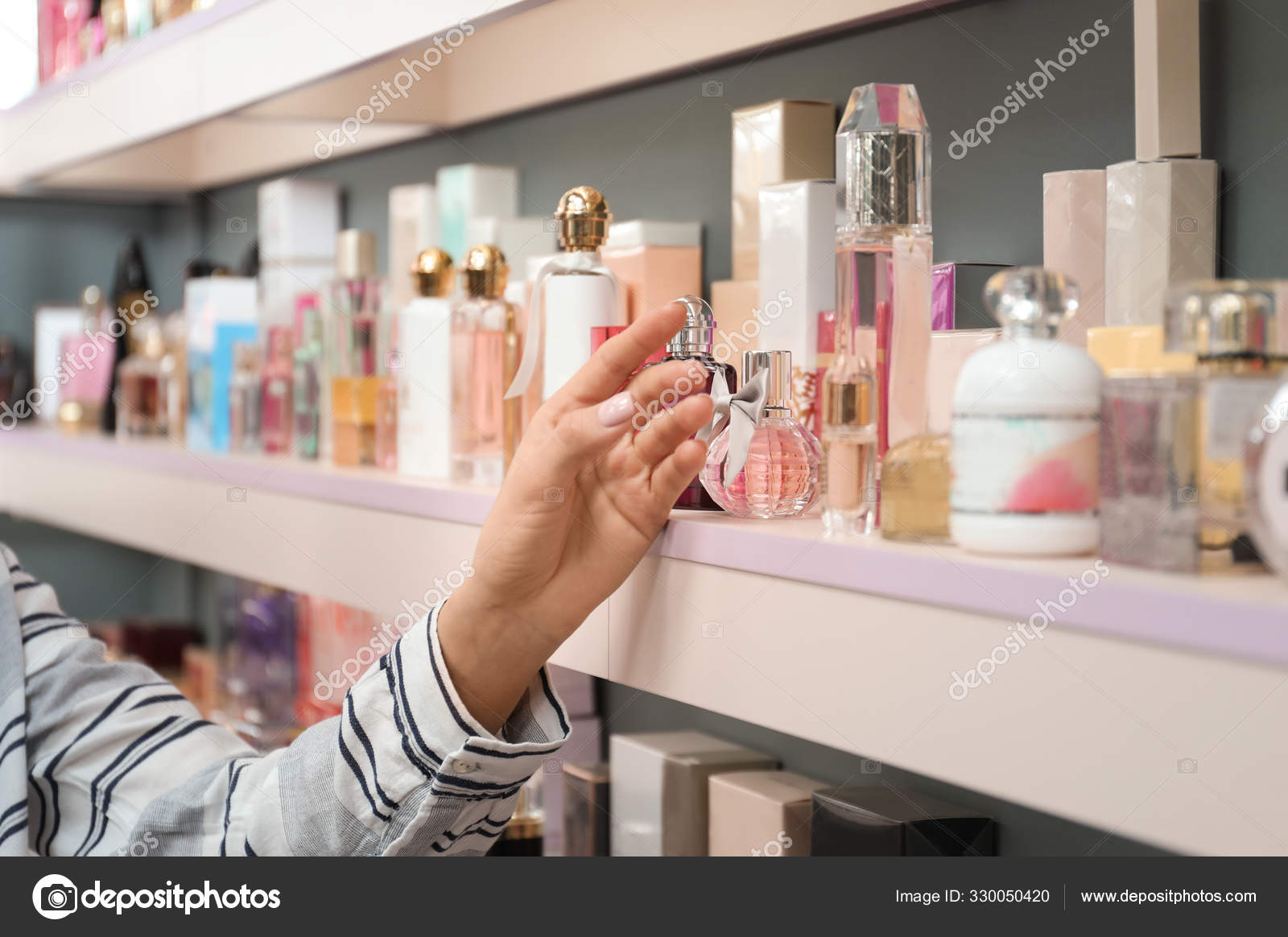Young Woman Shelves Perfume Bottles Shop Closeup Stock Photo by