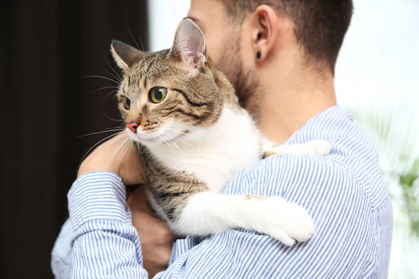 Man with cat at home. Friendly pet