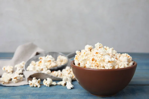 Tasty pop corn on blue wooden table