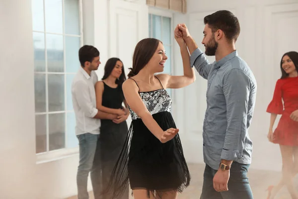 Lovely young couple dancing together at party — Stock Photo, Image