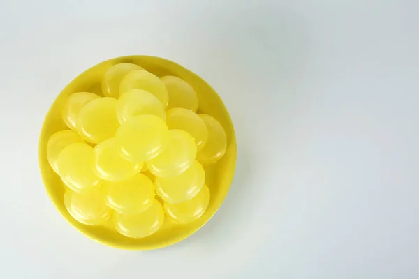 Tasty small lemon drops on white background, top view — 스톡 사진