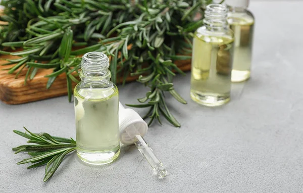 Fresh Rosemary Bottle Essential Oil Light Grey Table Space Text — Stock Photo, Image