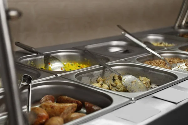 Containers with tasty food in school canteen