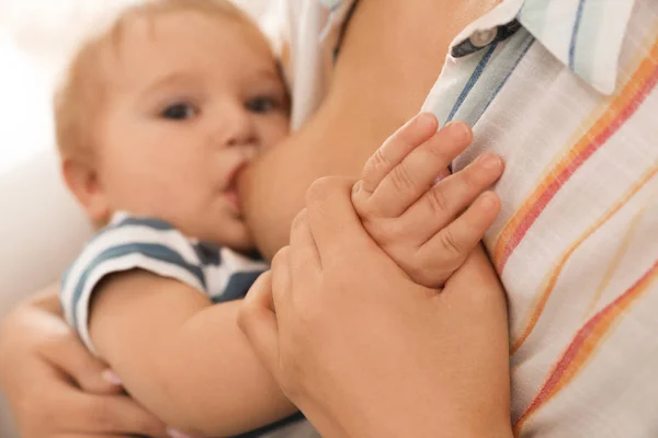 Woman breastfeeding her little baby, focus on hands — ストック写真